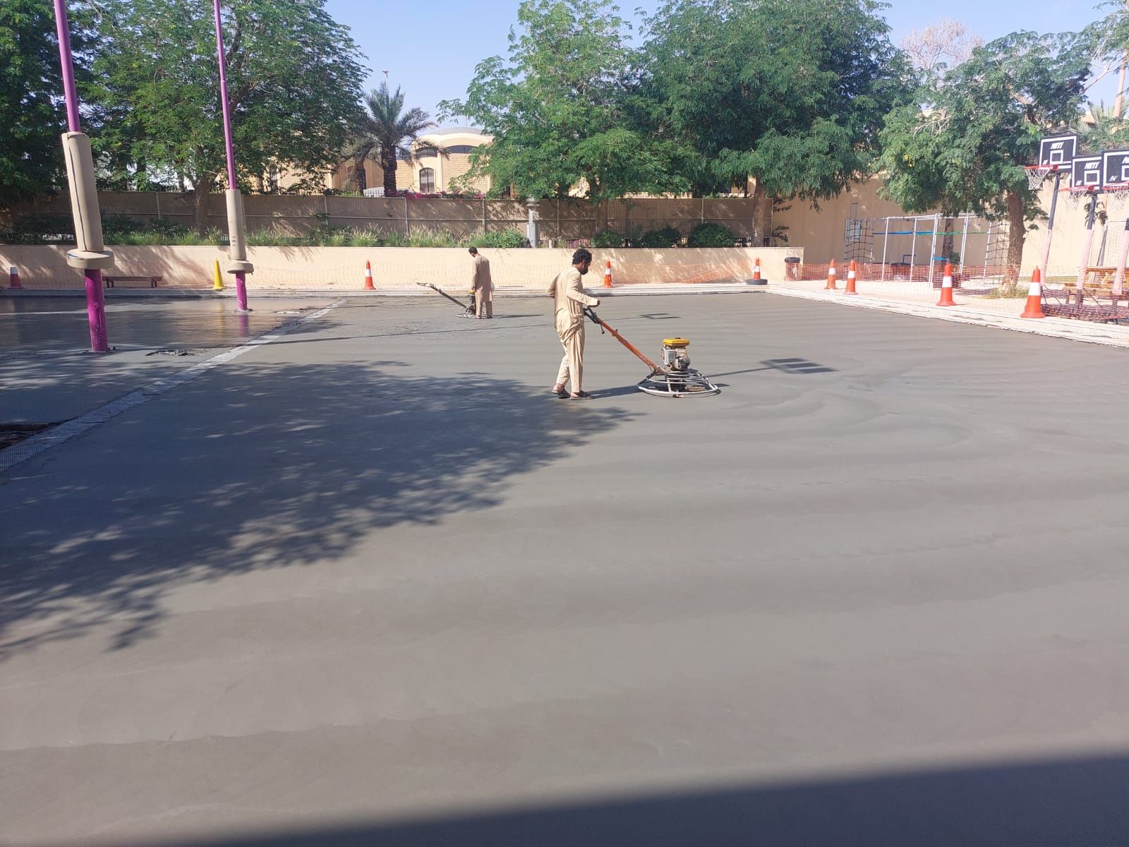 Power trowel machine finishing a fresh concrete slab